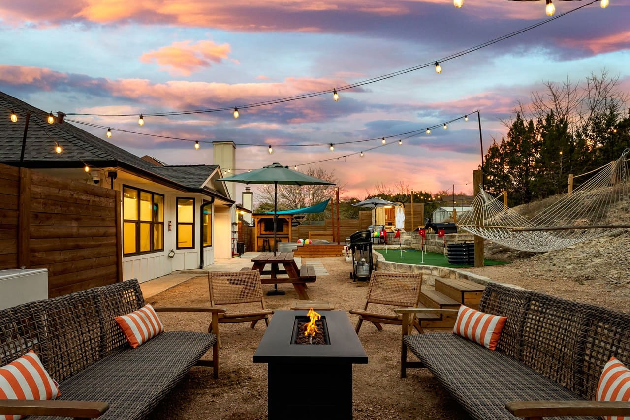Cowboy Ridge outdoor fire-pit lounge with hammock at dusk
